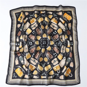 Detail of luxury silk scarf with vintage handbag patterns and striped borders