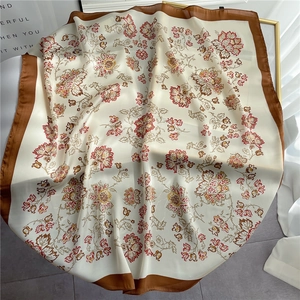 Detail of floral silk square scarf with brown border and vintage flower patterns