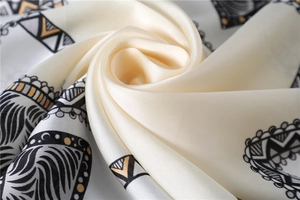 Close-up of elegant silk scarf with geometric patterns and smooth satin texture