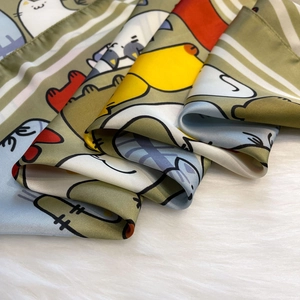 Detail van zijden satijnen sjaal met kleurrijke cartoon dierenprints en strepen