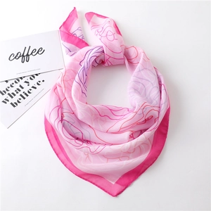 Detail of pink gradient chiffon square scarf showing soft texture and line print