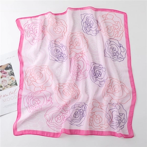 Detail of pink floral chiffon square scarf with abstract roses and elegant borders