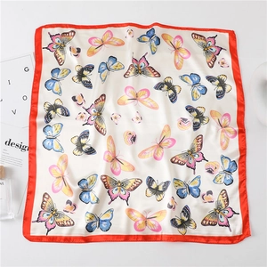 Elegant butterfly print square silk scarf with red borders on a minimalist white background