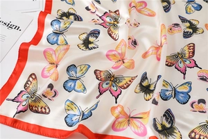 Detail of silk-feel square scarf with realistic butterfly patterns and red edges