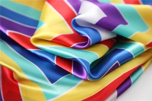 Macro view of silky satin scarf with colorful rainbow zigzag geometric stripe pattern
