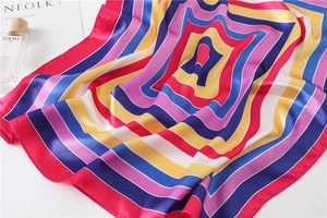 Detailed view of the soft satin striped scarf with colorful geometric patterns