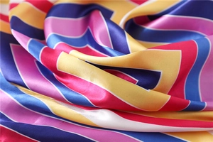 Detailed macro view of colorful geometric striped satin scarf with silky texture