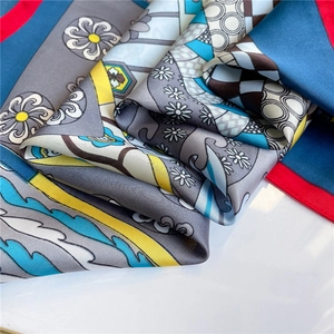 Detailed close-up of premium satin square scarf with geometric and floral print patterns