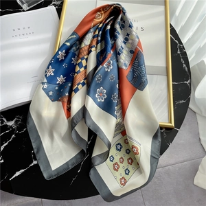 Elegant Morandi silk square scarf with colorful patchwork patterns on black marble table