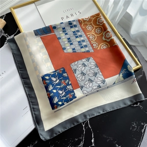 Elegant Morandi silk scarf with geometric floral patterns on black marble surface