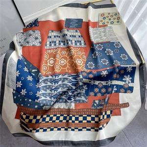Detail of elegant multicolor silk scarf featuring sailboat motifs and satin texture