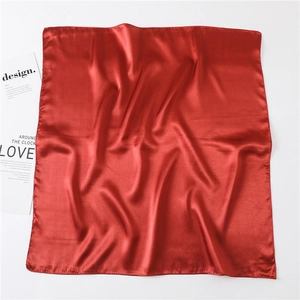 Detail of red square silk scarf with premium satin finish and neat edge stitching