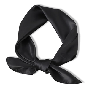Detail of a knotted black satin square scarf with a elegant silky texture and gloss