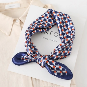 Plaid faux silk neck scarf in blue and orange geometric pattern tied in a knot