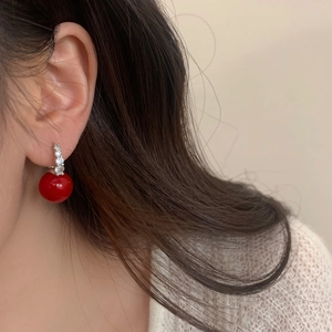 Elegante rote Kirschperlen-Ohrhänger mit funkelnden Kristallen am Modell getragen