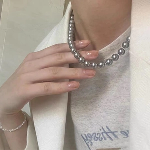 Detailed view of elegant grey pearl necklace with 8-10mm glossy beads on female model