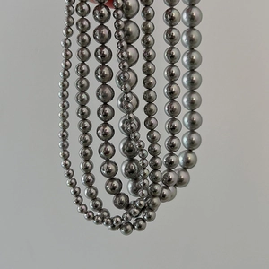 Detail view of grey pearl necklace showing various bead sizes from 5mm to 12mm diameter