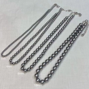 Comparison of grey pearl necklaces in 4mm, 6mm, 8mm, and 10mm sizes with metal clasps