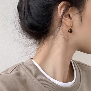 Retro golden tiger eye bead hook earrings shown on a model with elegant vintage style