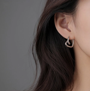Minimalist silver heart-shaped ear buckles with elegant overlapping double heart design