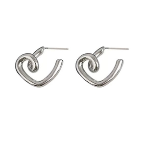 Minimalist silver heart-shaped metal stud earrings with a sleek streamlined design