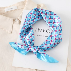 Close-up of blue and white checkered silk scarf on shirt and Kinfolk magazine