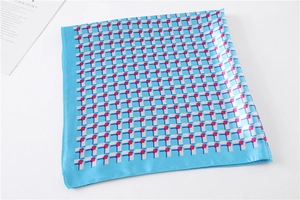 Detail of blue square satin scarf with geometric print and hand-rolled stitched edges