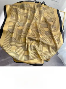Detail of silk-like geometric scarf with yellow and black linear maze patterns