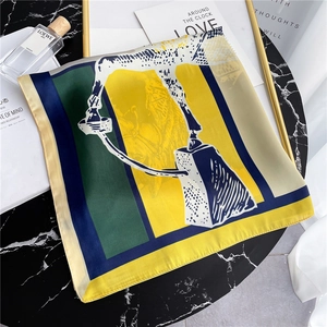 Detail of artistic silk scarf with abstract horse pattern on marble table