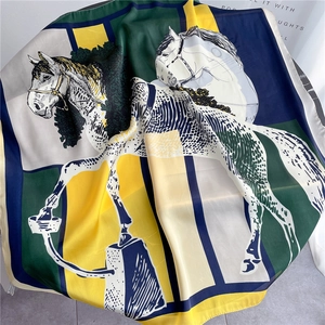Detailed view of silk-like scarf featuring horse print and colorful geometric design