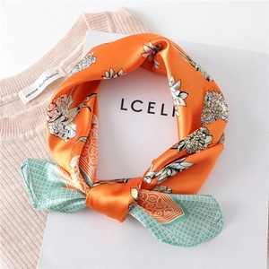 Detail of silk scarf showing floral patterns and mint green geometric diamond patterns