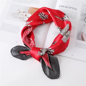 Elegant red silk scarf with floral and geometric diamond patterns tied in a bow knot