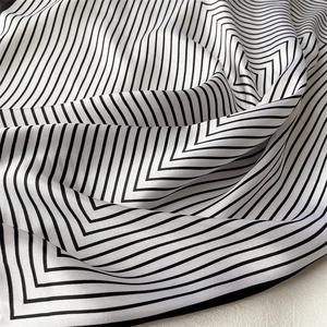 Macro shot of striped silk scarf texture with classic black and white chevron pattern