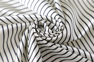 Macro shot of striped satin fabric showing silky texture and elegant draping effect