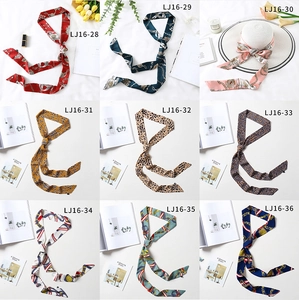 Collection of chic skinny silk scarves in nine patterns with elegant lifestyle props