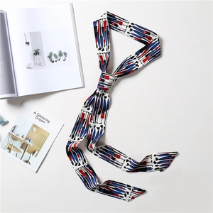 Detail of a white silk scarf with abstract fashion patterns and a satin finish