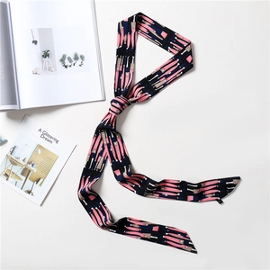 Detail view of thin silk scarf with pink and black abstract pattern on white background