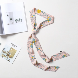 Detail of pink floral silk scarf with wheat patterns and smooth texture on white background