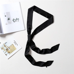 Detail of a thin black satin narrow scarf showing elegant texture and knotting detail