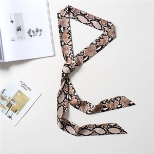 Close-up of a long silk-feel scarf with stylish brown snakeskin print on white background