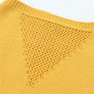 Detailed macro view of ginger yellow knitted neck gaiter with hollow triangle patterns