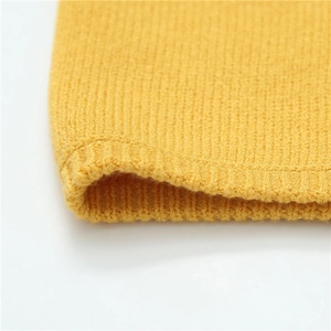 Detailed macro view of the bright yellow ribbed knit texture on this warm winter neck gaiter