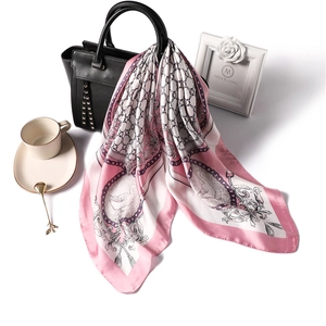 Elegant 70cm silk scarf with chain and swan pattern draped on a luxury black handbag