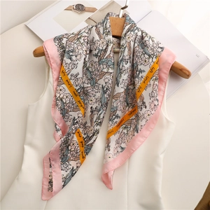 Close-up of floral print silk scarf with yellow ribbon accent showing elegant patterns