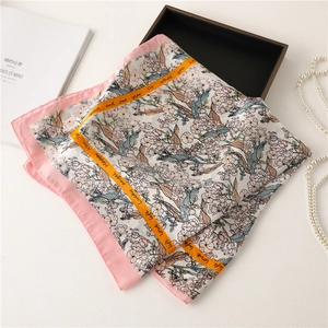 Detail of floral silk scarf with pink edges and elegant Lucky Angel decorative text