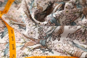 Detailed macro view showing the silky texture and elegant floral print on this chic scarf