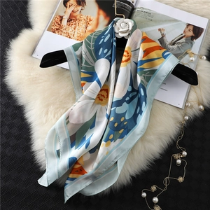 Elegant 70cm floral print silk square scarf with daisy pattern on a premium display