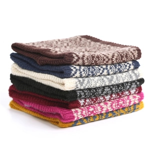 Stack of warm fleece-lined knit neck warmers showing various colors and textures