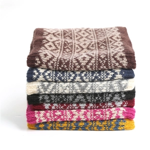 Detail of stacked winter knit neck warmers with vintage geometric Fair Isle patterns