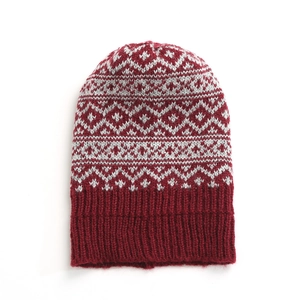 Detail of winter knit beanie showing maroon and grey diamond patterns and ribbed cuff